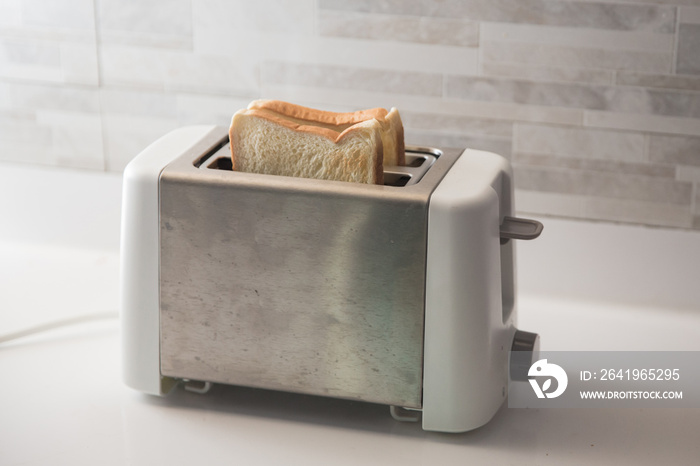 bread on toaster in the kitchen for breakfast