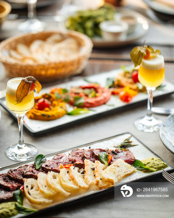 Gourmet appetizers roast beef and assorted hummus with shot cocktails