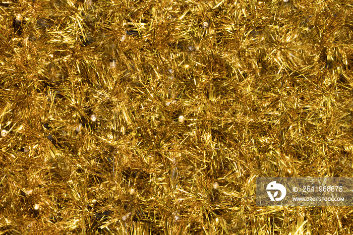 Close up gold tinsel Christmas background.