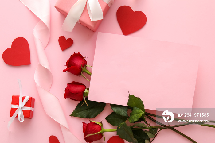 Composition with blank card, red rose flowers and gifts on pink background. Valentines Day celebrat