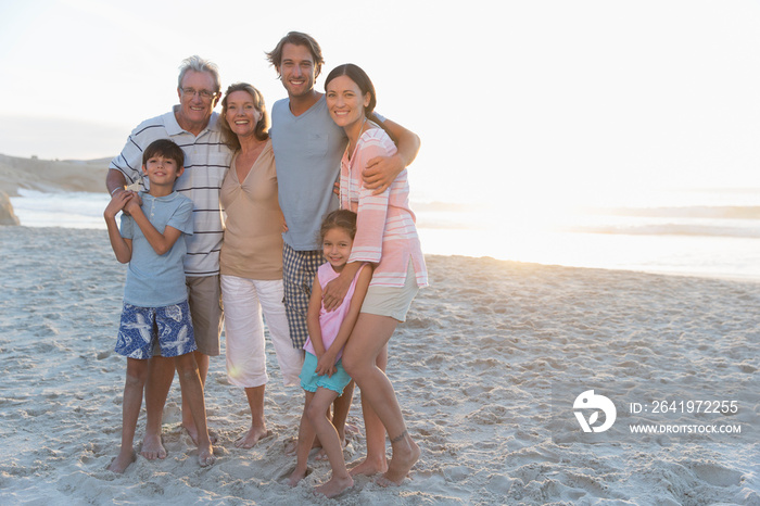 Portrait happy multi-generation family on sunny beach