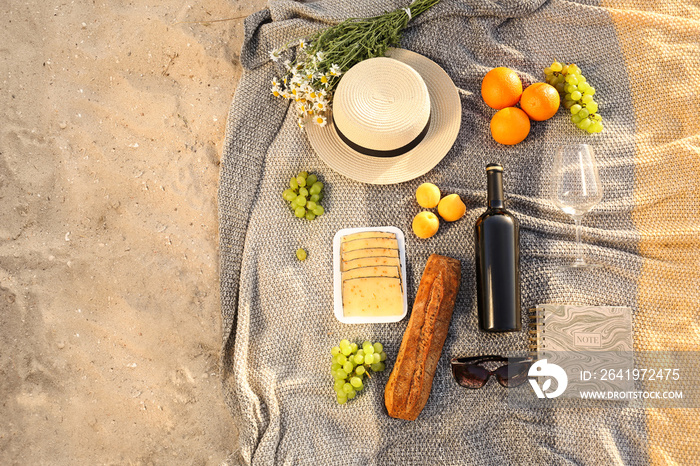 Tasty food and drink for romantic picnic on beach