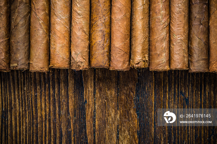 Hand rolled cigars on wooden table