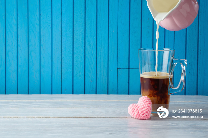 Mothers day concept with coffee cup and heart shape on wooden table.