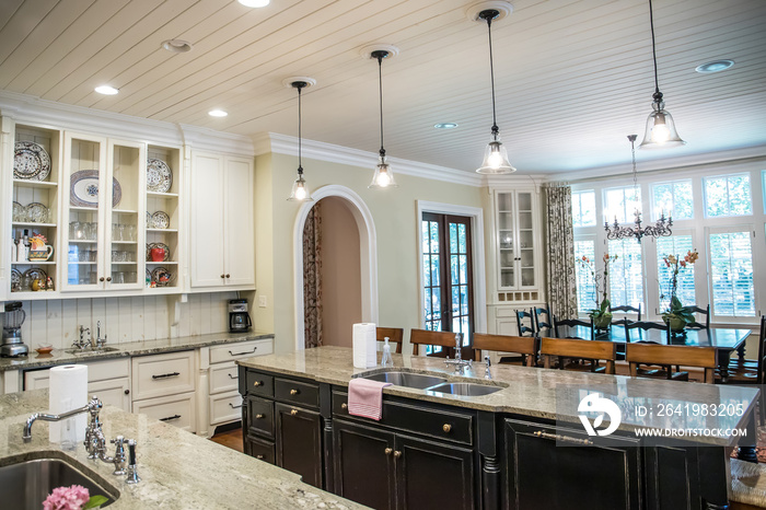 large kitchen with eat-in dining at spacious granite countertop and barstools. Pendant lighting and 