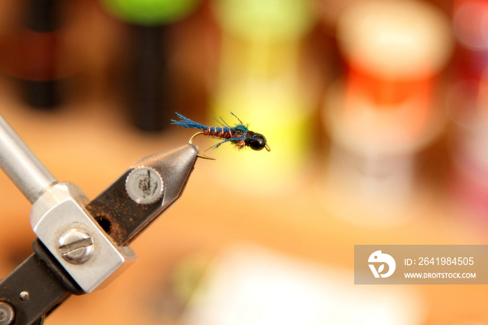 A closeup image of a freshly tied fly (fishing lure).