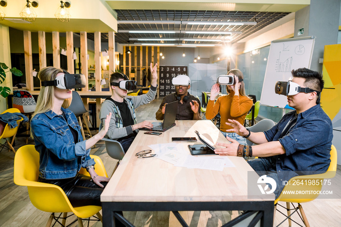 Five multiracial young students wearing virtual reality glasses indoor - Happy people having fun wit