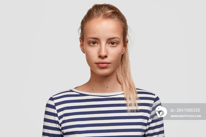 Close up portrait of beautiful female trainer in casual striped t shirt, waits for new group for tra