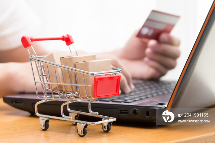 Hand men using laptop and buy goods from a seller over the internet. online shopping concept