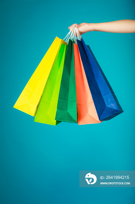 女性手中的彩色购物袋。销售零售