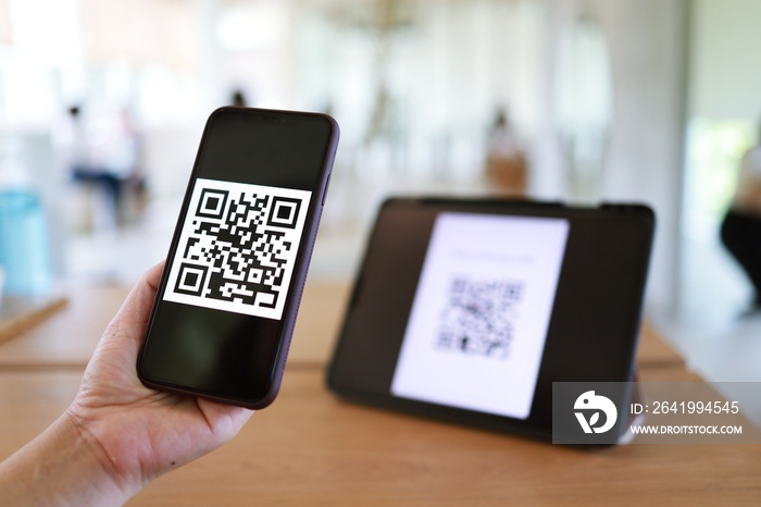 Qr code payment. Woman scanning QR code online shopping cashless technology concept.