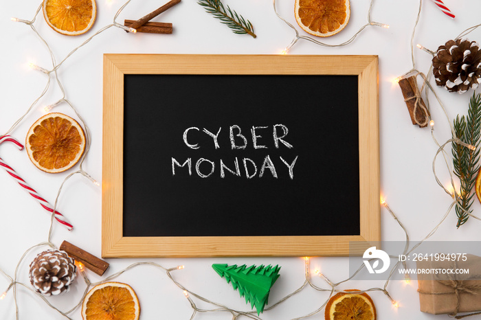 online shopping, sale and marketing concept - black chalk board with cyber monday words and christma