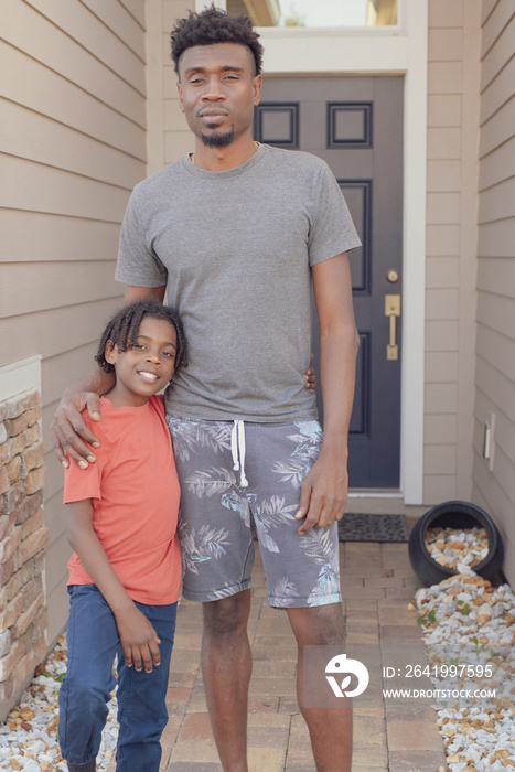 Father and Son in front of home