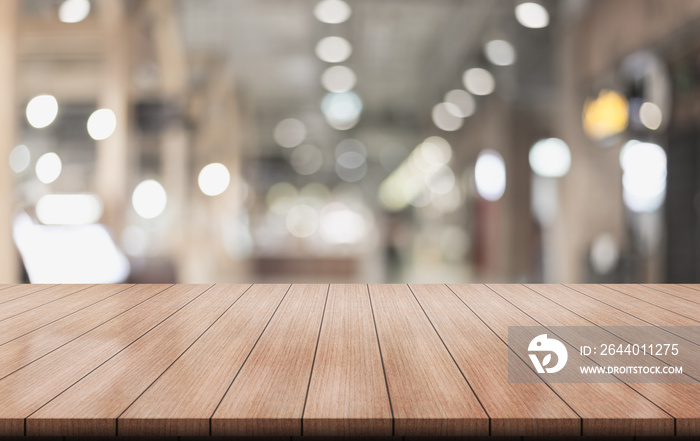 Empty wooden table top with lights bokeh on blur restaurant background.