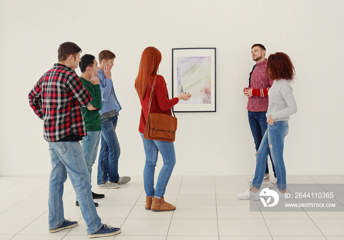 Young people in modern art gallery hall