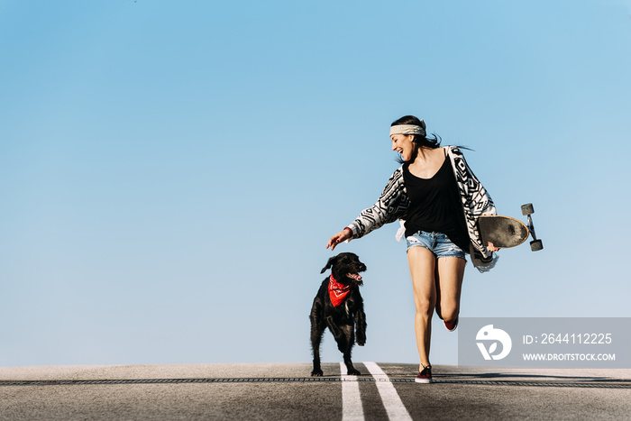 Beautiful young playing with her dog.