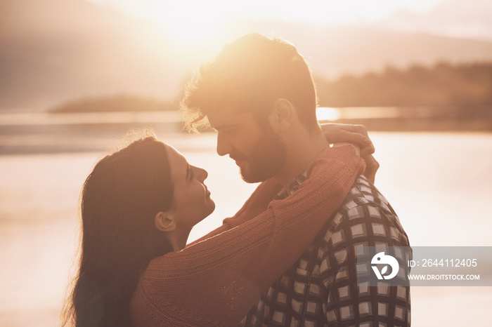 Romantic loving couple kissing at sunset