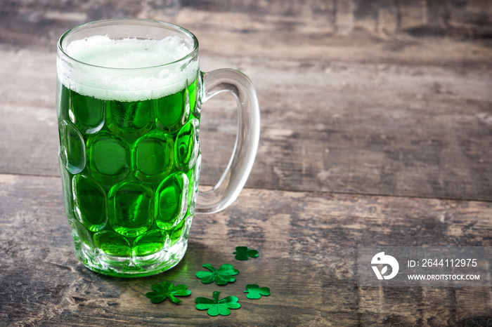 Traditional cold green beer on wooden table for Saint Patricks Day. Copyspace.