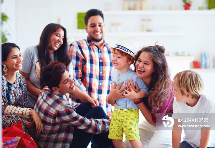 group of cheerful friends having fun together, playing with kids