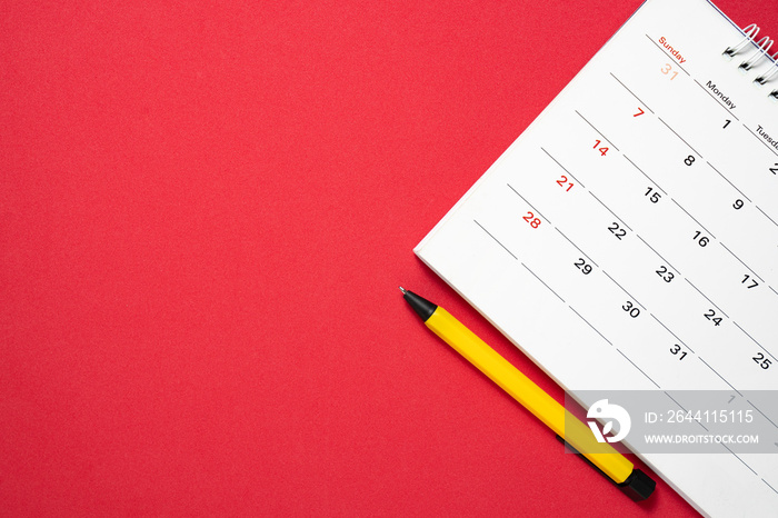 close up of calendar and pen on the red table, planning for business meeting or travel planning conc