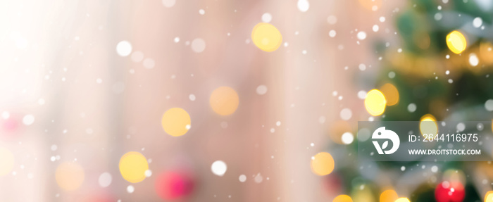 Blur Christmas tree with snow and bokeh from decorative light