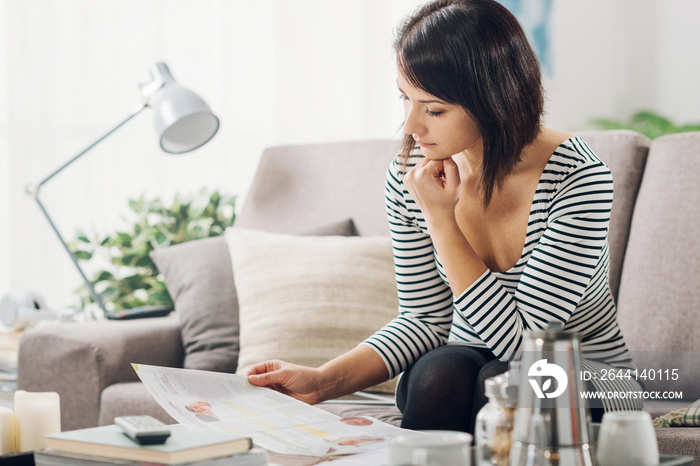 Woman reading a magazine on the couch