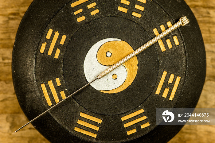 acupuncture needle on Chinese Taoism symbol