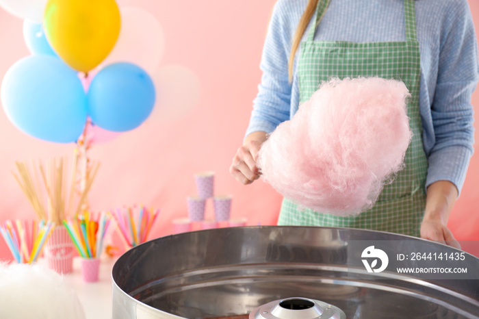 Woman making cotton candy at fair