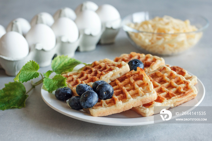 Chaffles with blueberry. Egg and cheese waffles for breakfast. Keto diet. Cheese waffle.