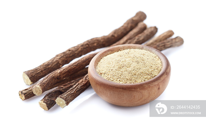 Licorice powder with dry roots on white background