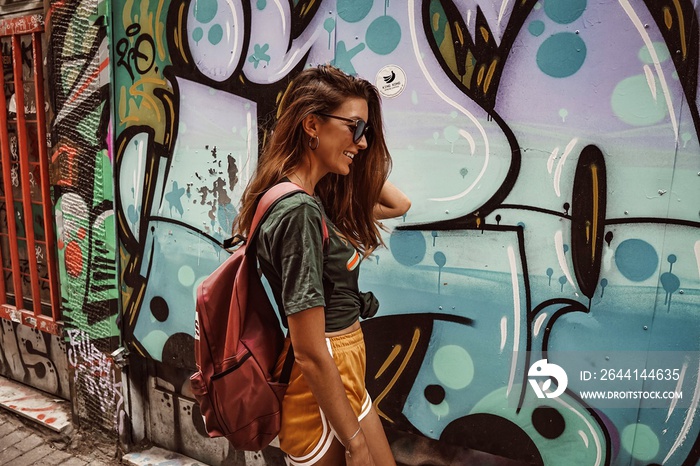 woman with a graffiti wall