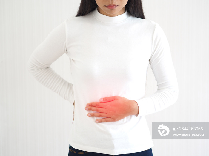 appendicitis and constipation, including gastroenteritis in asian woman and she touching her abdomen