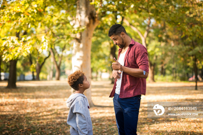 Father criticizing his disobedient child for bad behavior. Children upbringing.