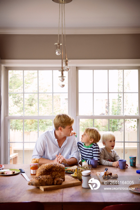 Two brothers (4-5, 6-7) having breakfast