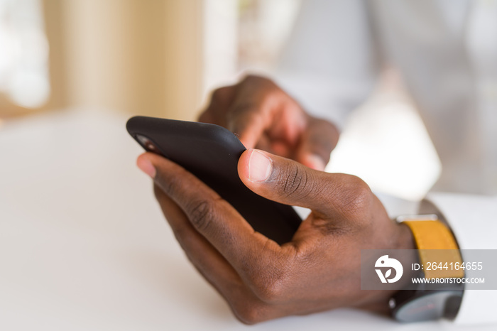 Close up of african man hands using smarpthone