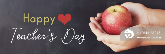 Student hands holding red apple with blackboard background, Happy teachers day