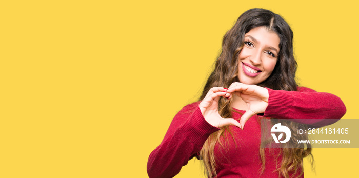 Young beautiful woman wearing red sweater smiling in love showing heart symbol and shape with hands.