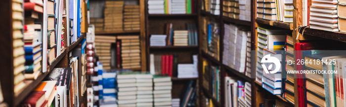 panoramic shot of retro books on shelves in library