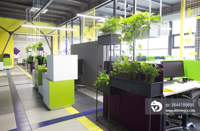 Open space interior with green plants and places for workers