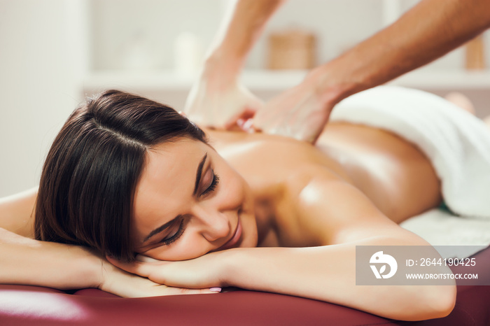 Young woman is enjoying massage on spa treatment.