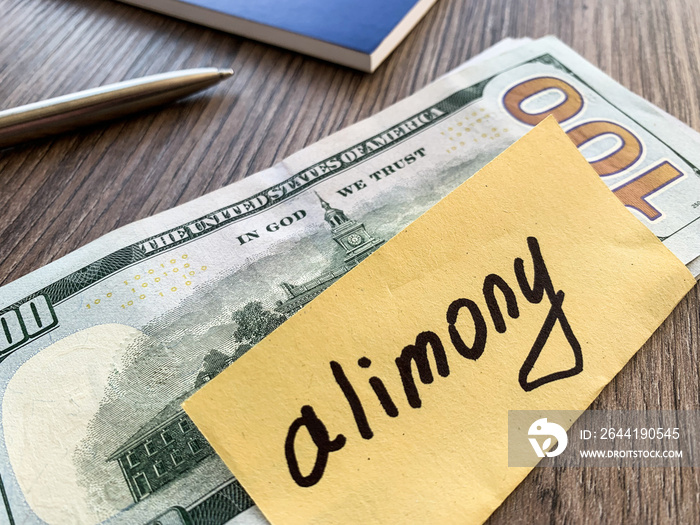 Payments alimony. Pile Dollars with sign alimony and money. Divorce and separation concept.