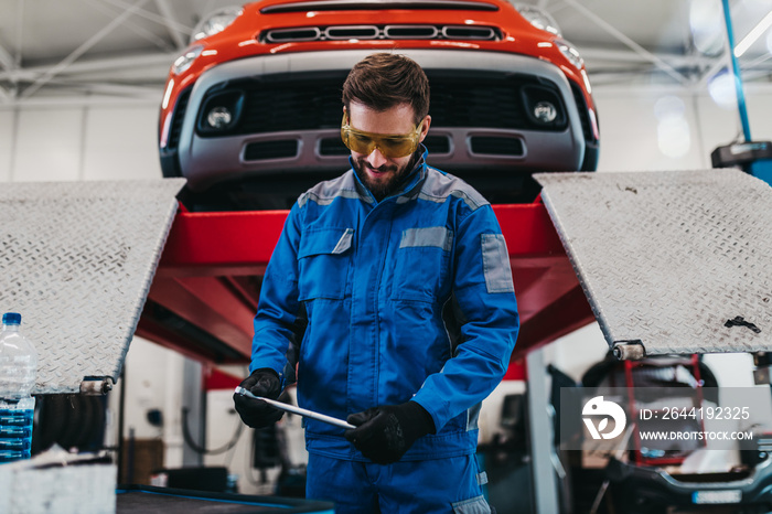 A professional mechanic working in a car service.