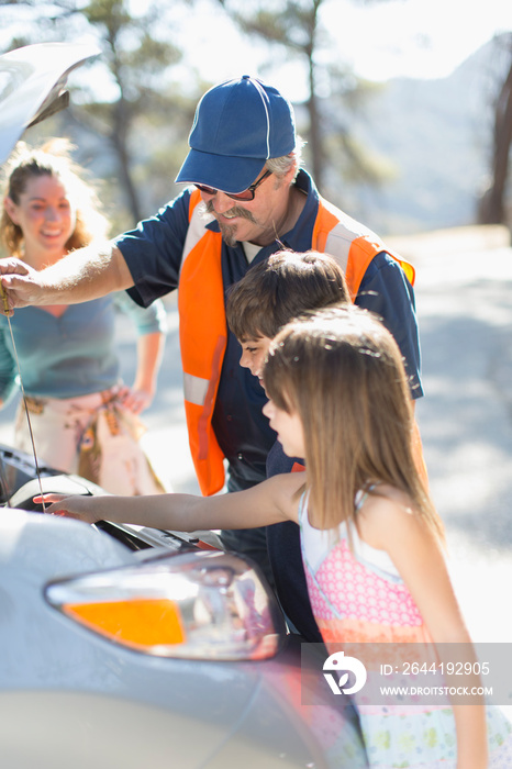 Roadside assistance mechanic helping family with vehicle breakdown