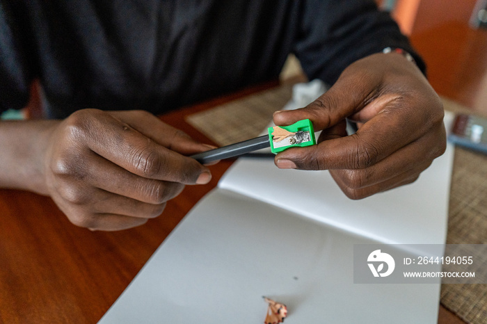 person sharpening a pencil