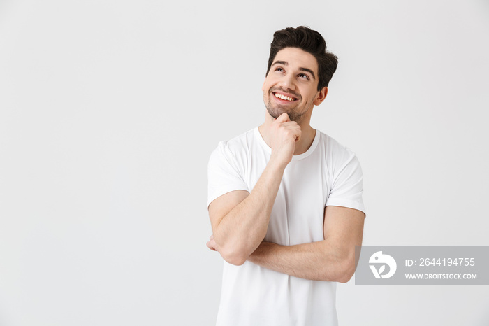 Happy young excited emotional man posing isolated over white wall background.