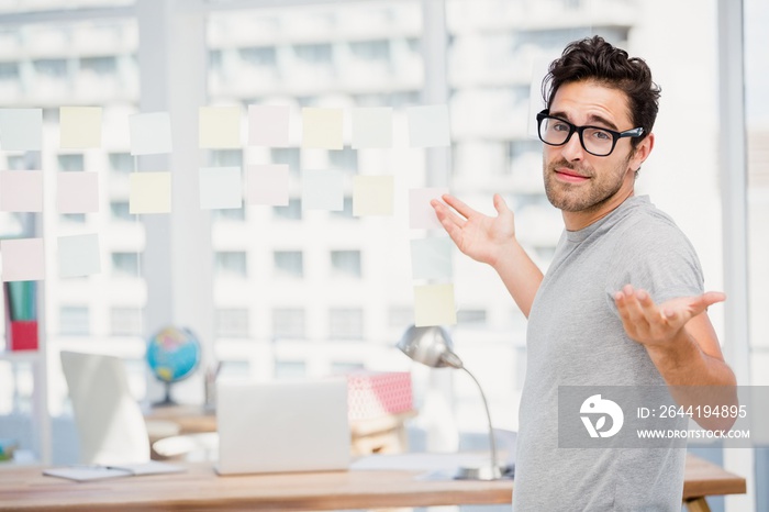 Man shrugging his shoulder in office