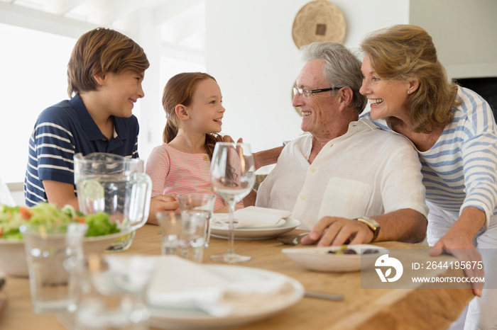 Grandparents and grandkids eating lunch at table