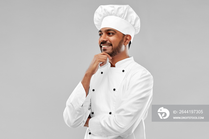 cooking, profession and people concept - happy male indian chef in toque over grey background