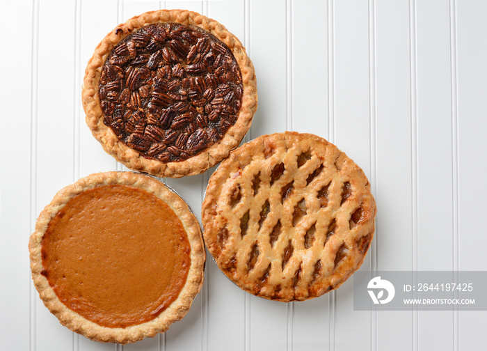 Three pies, Apple, Pumpkin, and Pecan. Pies are favorite desserts for the American Holidays, Thanksg