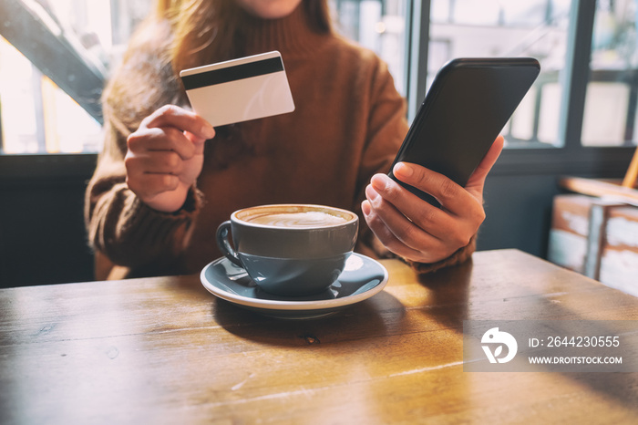 A woman using credit card for purchasing and shopping online on mobile phone